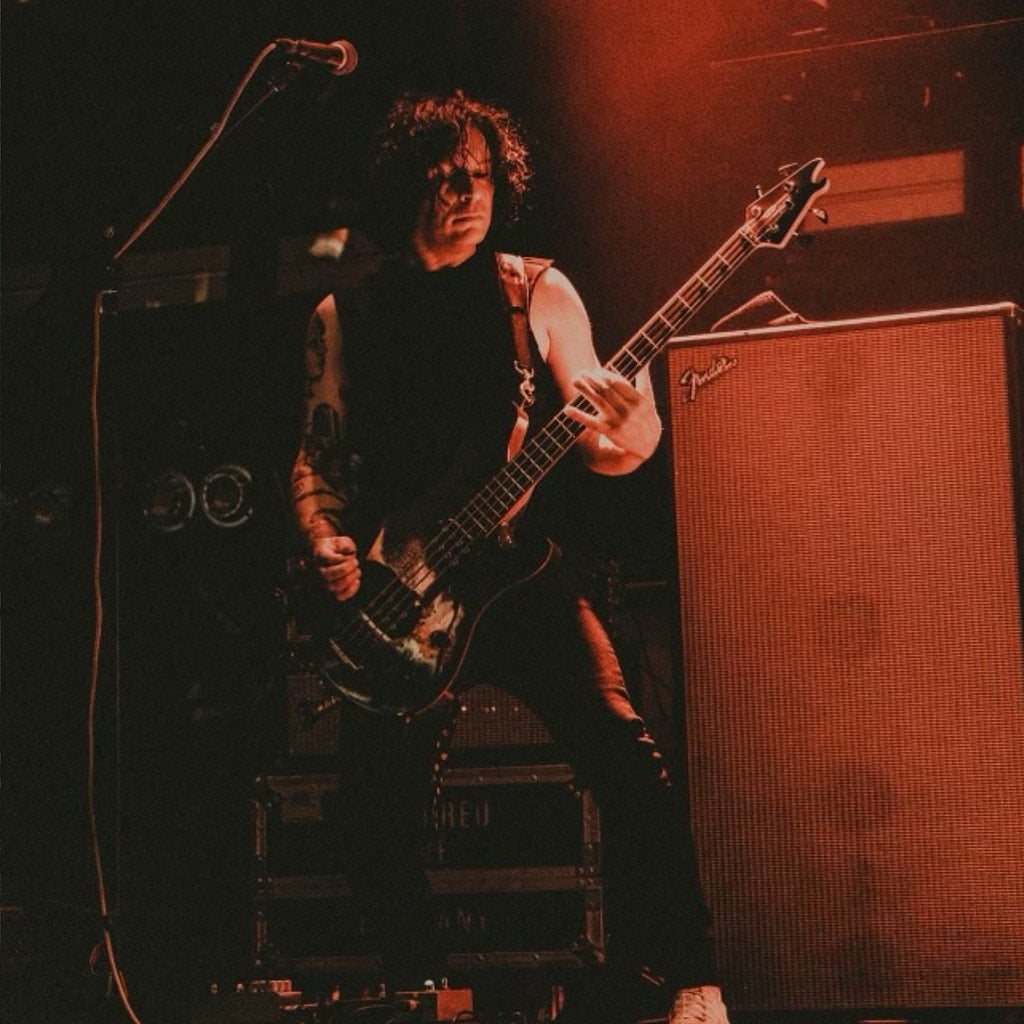 Ronnie Ficarro playing bass on stage.