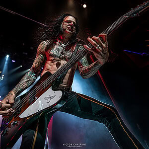 Chuck Garric playing his firebird bass on stage.